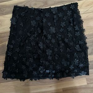 Black mini skirt with flower lace overlay. Never worn